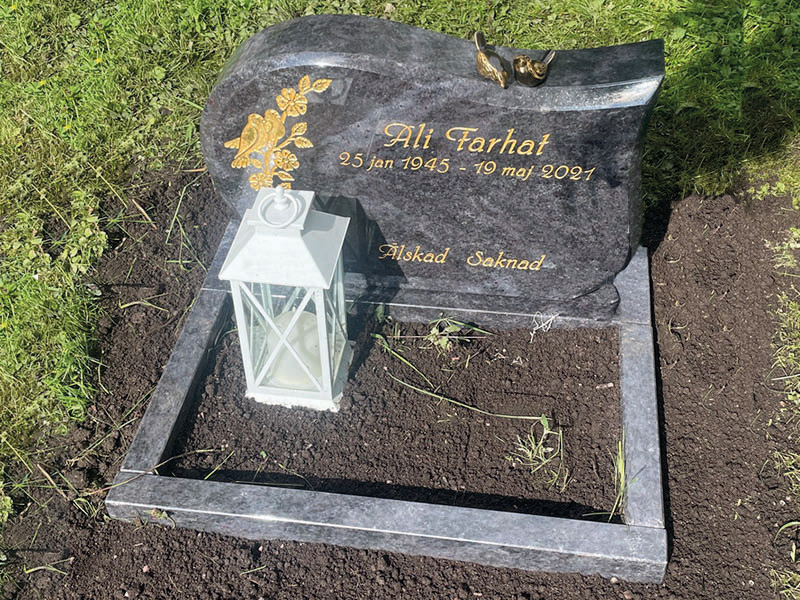 E007 i indisk blågrå granit och anpassad storlek. Försänkt förgylld gravyr, bronssparvar samt polerad blomlist.