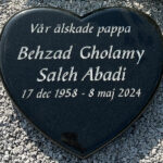 E022 in polished black granite. The engraving is recessed and painted antique white.