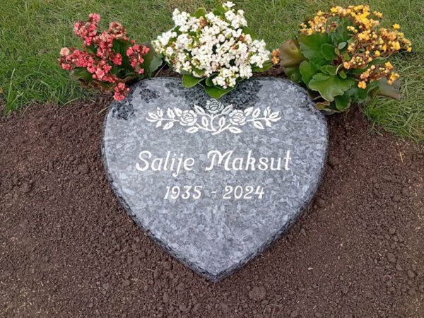 E022 in polished Labrador granite. Text and decoration are recessed and painted silver.