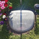 EN115 in fully polished grey Kuru granite. Recessed antique-white engraving, modified decoration.