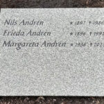 EN201 in grey Kuru granite, recessed engraving painted black.