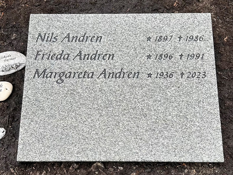 EN201 in grey Kuru granite, recessed engraving painted black.