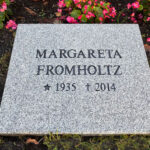 EN201 in grey Kuru granite, recessed engraving painted black.
